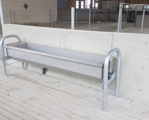 New galvanized cow water trough in dairy cow barn